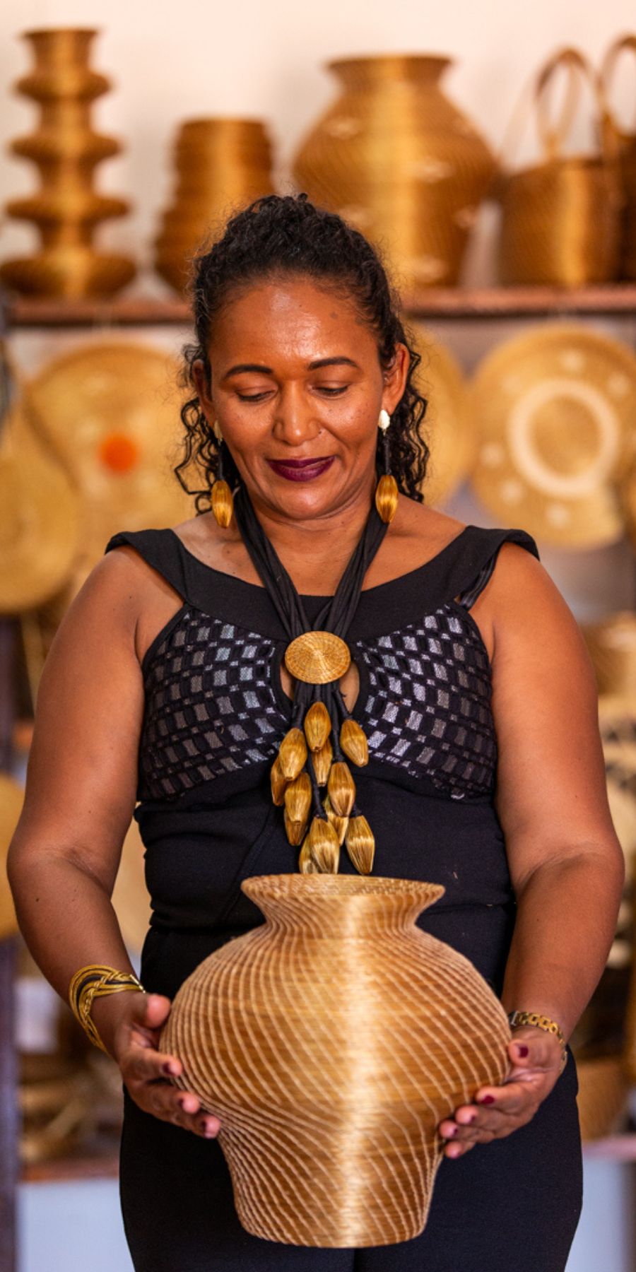 “Brazilian handmade golden grass earrings and baskets by Mumbuca artisans”