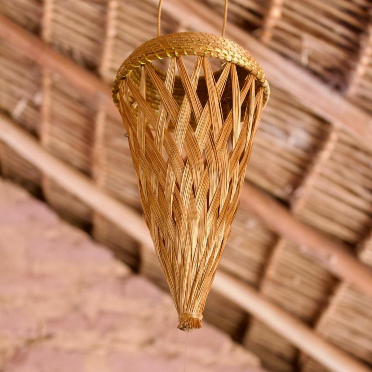 Handmade golden grass luminaire for sustainable home décor, crafted by Brazilian artisans